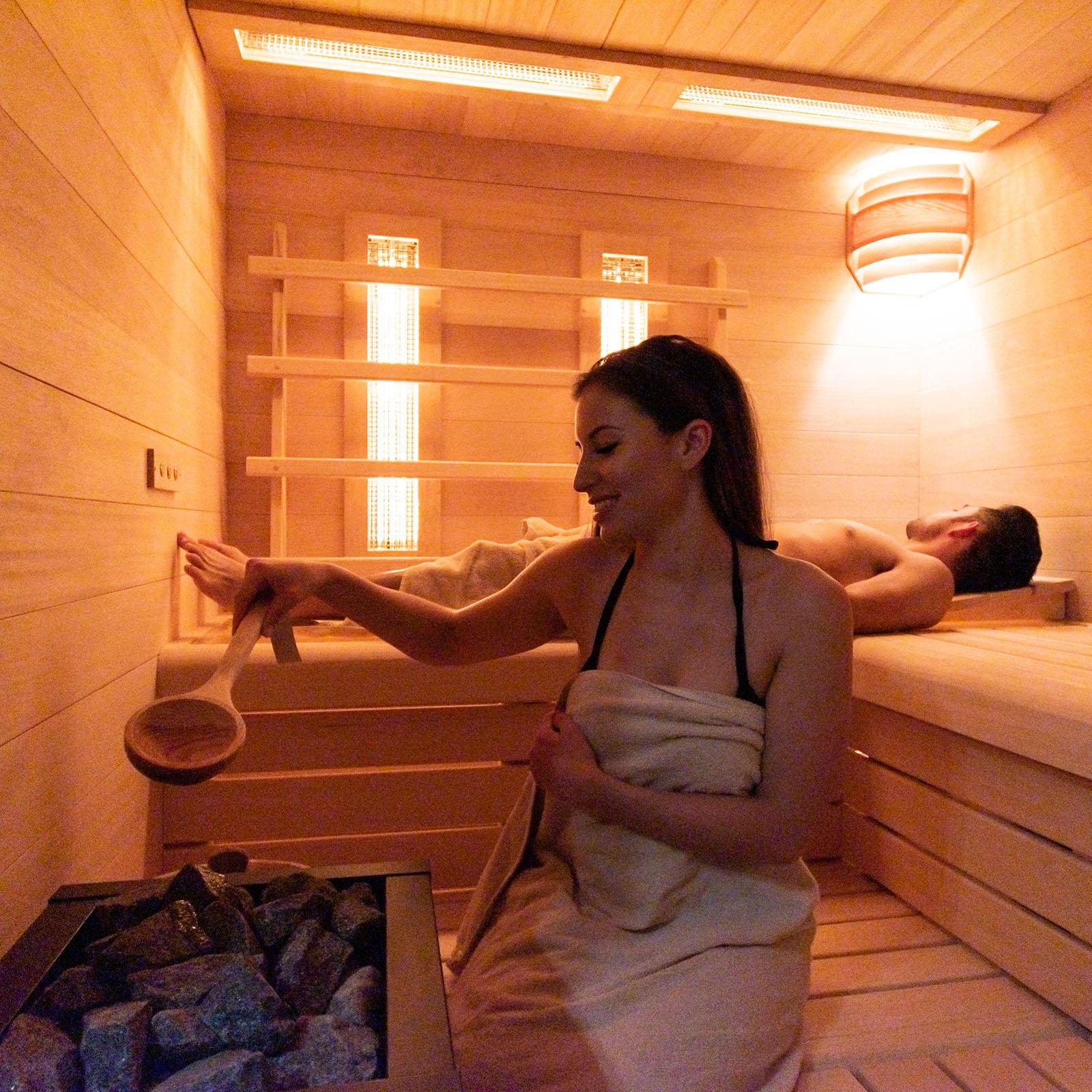 Een man en een vrouw in de sauna bij Holiday Suites Zeebrugge