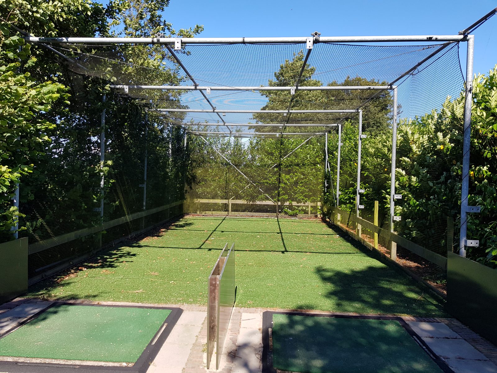 Two golf driving practice cages