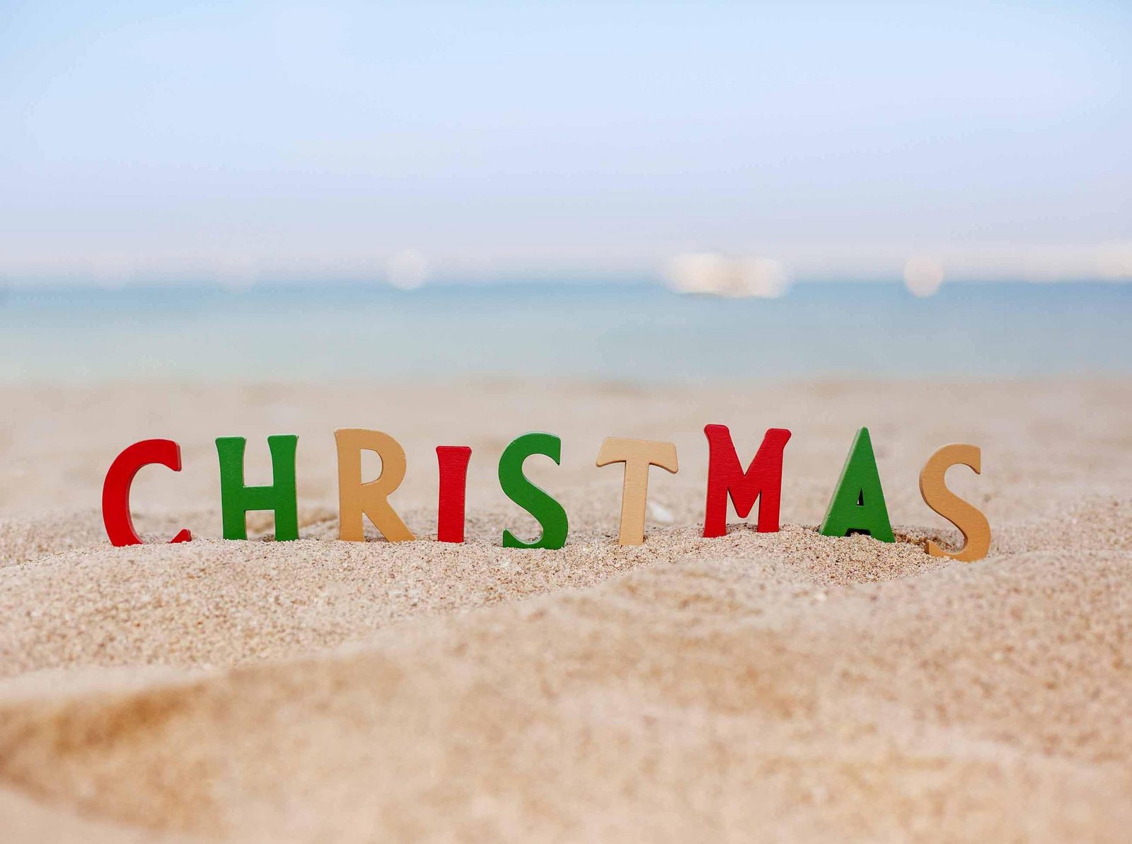 Word Christmas on the beach in Christmas colors