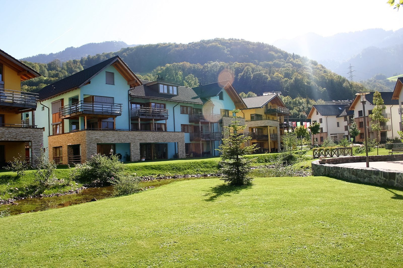 Holiday homes along the little stream of Resort Walensee in Heidiland Flumserberg Switzerland, during the Easter holidays